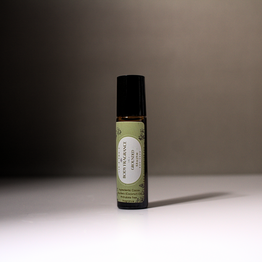 All Natural Roll On Body Perfume in brown glass with black top with green + white label with black writing